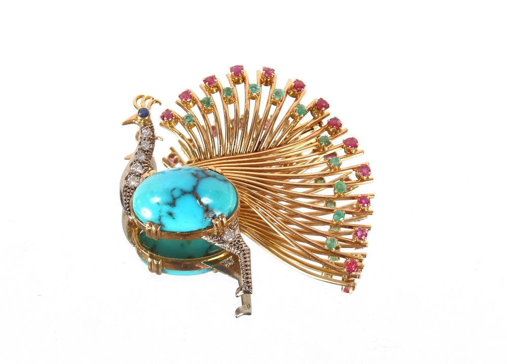 An impressive 18ct gold peacock brooch, set with diamonds, rubies, emeralds and sapphire around a