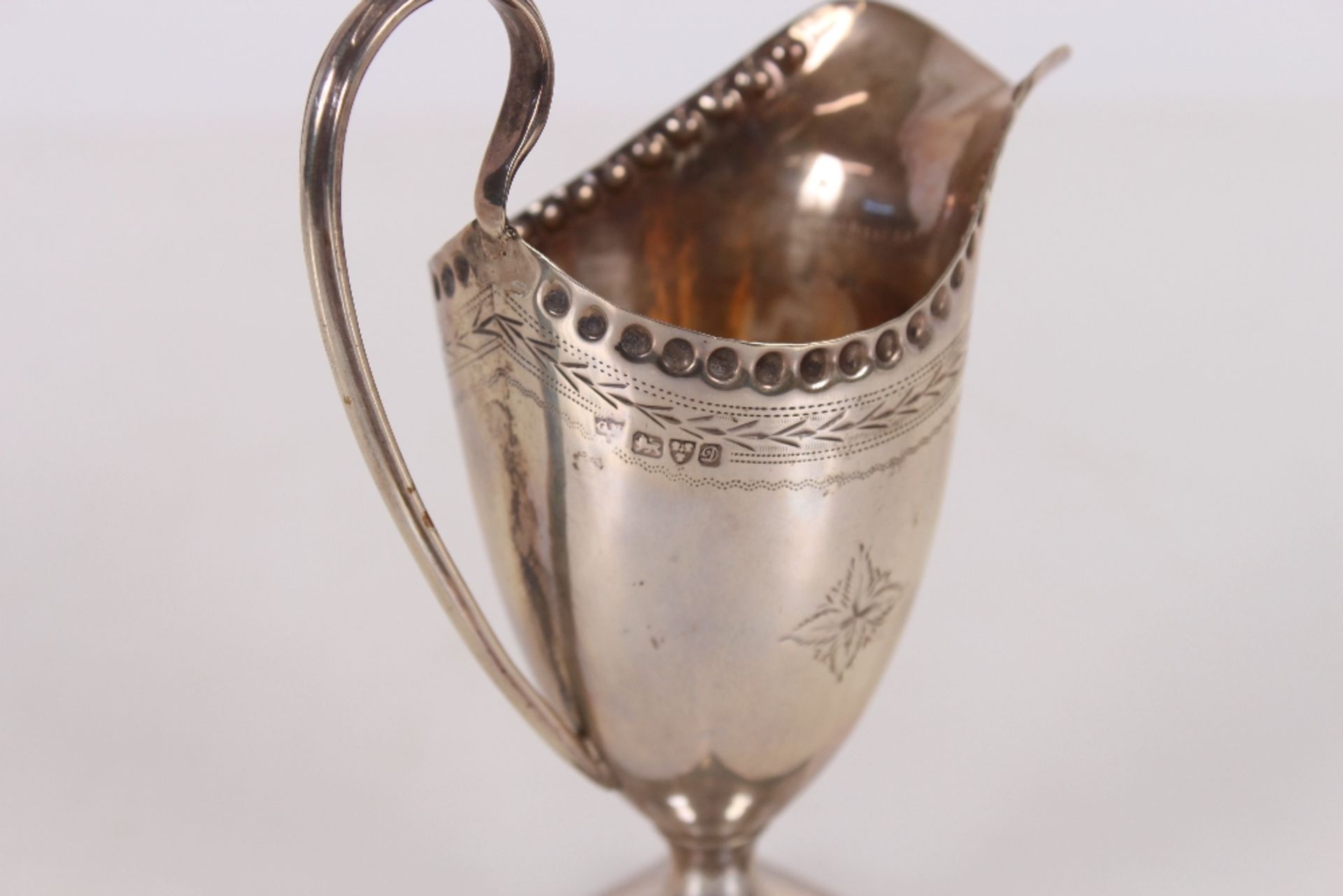An Edwardian silver pedestal cream jug, having foliate line decoration, spread foot and square base, - Image 3 of 3