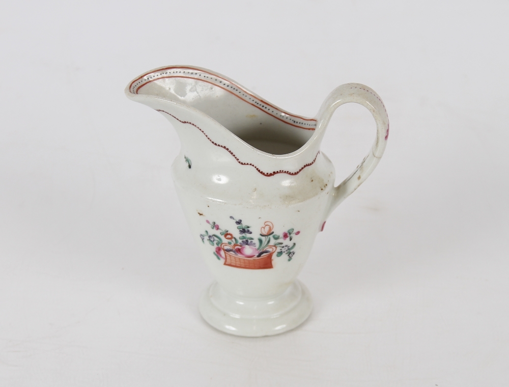A Newhall porcelain cream jug, decorated basket of flowers with sprays, 11.5cm high