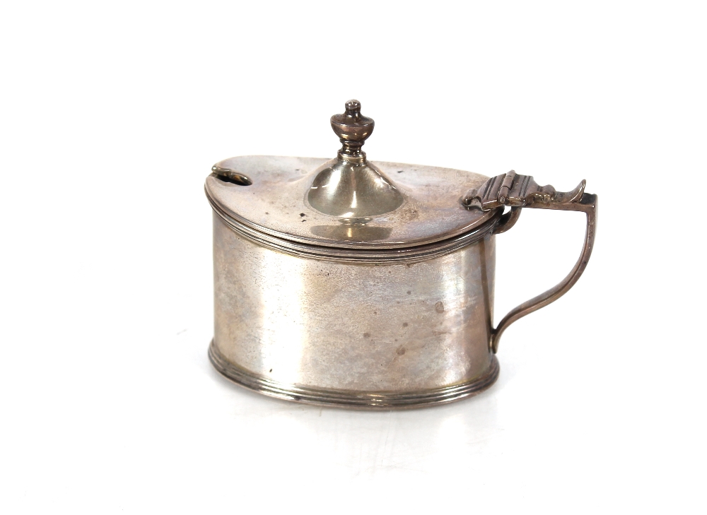 A late Victorian silver oval mustard pot, with blue glass liner, Birmingham 1896; and an Eastern