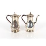 A George V silver Café au Lait set of baluster form, the domed hinged lids surmounted by acorn