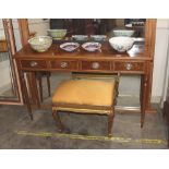 A walnut and cross banded hall table, fitted four drawers raised on turned tapering supports,