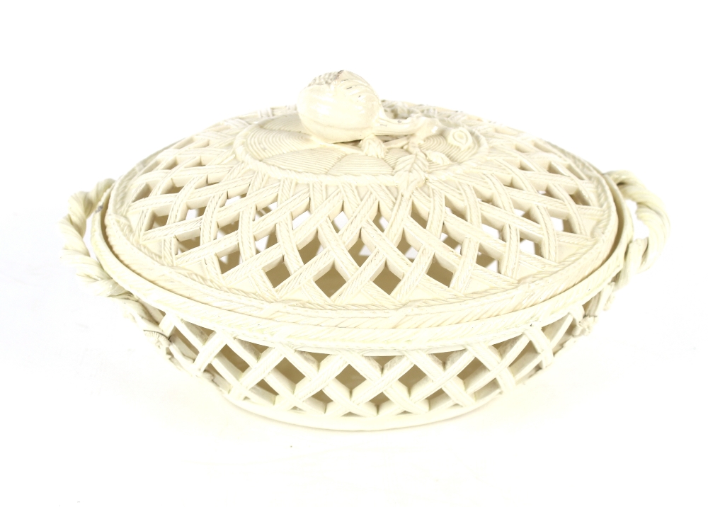 A 19th Century cream ware basket and cover with fruit finial, flanked by twist handles, 27cm long