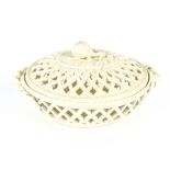 A 19th Century cream ware basket and cover with fruit finial, flanked by twist handles, 27cm long