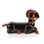 An Oriental carved and painted wooden figure of a reclining ram, 80cm long overall