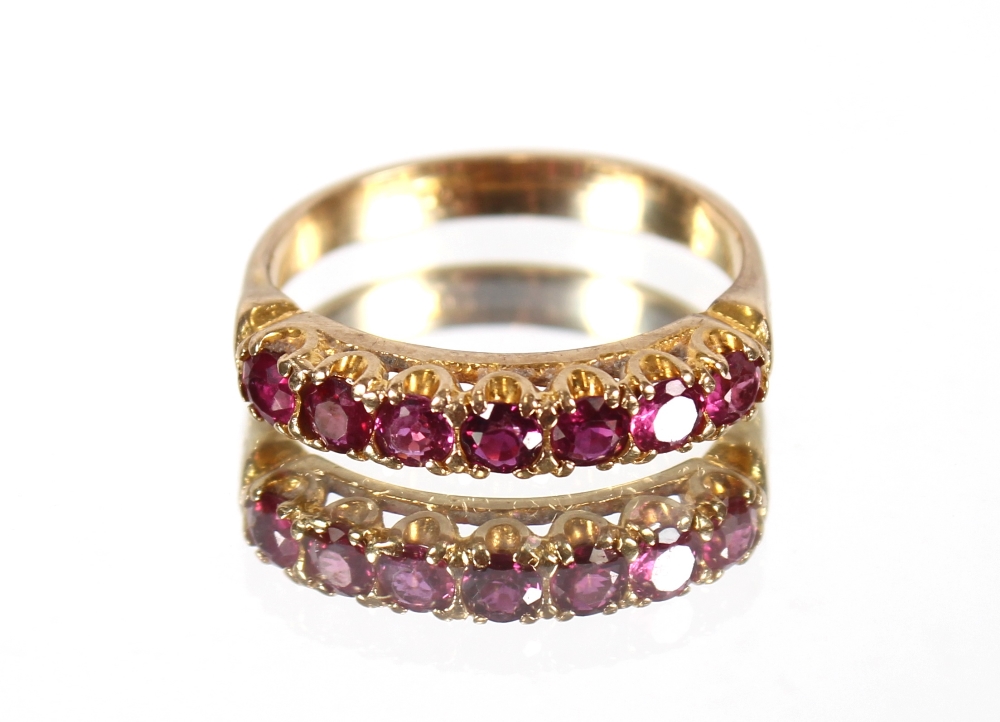 A 9ct gold ruby seven stone half eternity ring, 3g