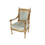 A pair of 19th Century French gilt wood armchairs, the back surmounted by pineapple finials above