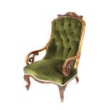A Victorian walnut framed spoon back armchair, having carved foliate cresting, buttoned green Dralon