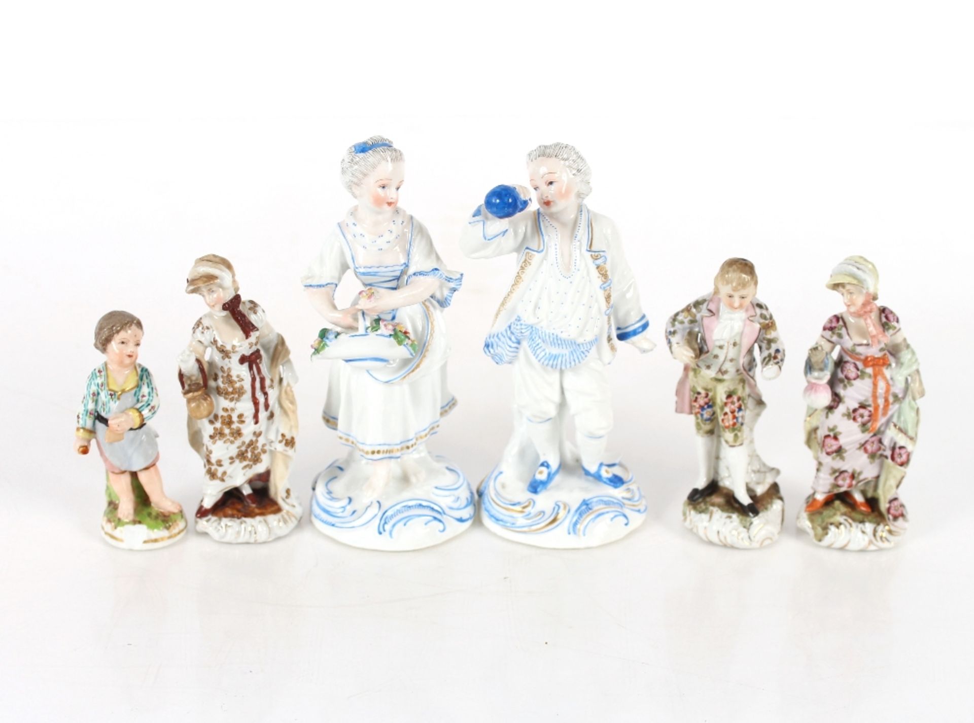 A Meissen style porcelain figure of a young boy; three German porcelain figures of two maids and a