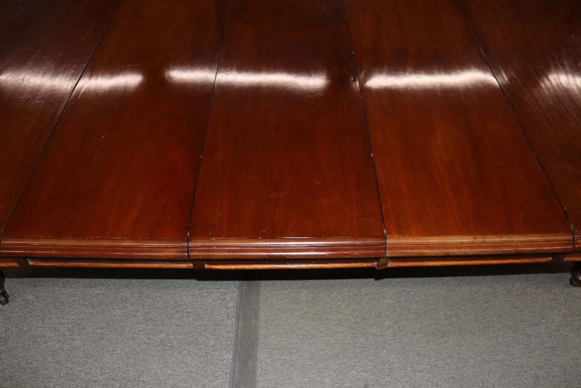 A large Victorian mahogany extending dining table with three extra leaves, raised on leaf carved and - Image 4 of 7