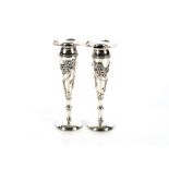A pair of slender Chinese silver trumpet shaped spill vases, decorated with hand worked floral and