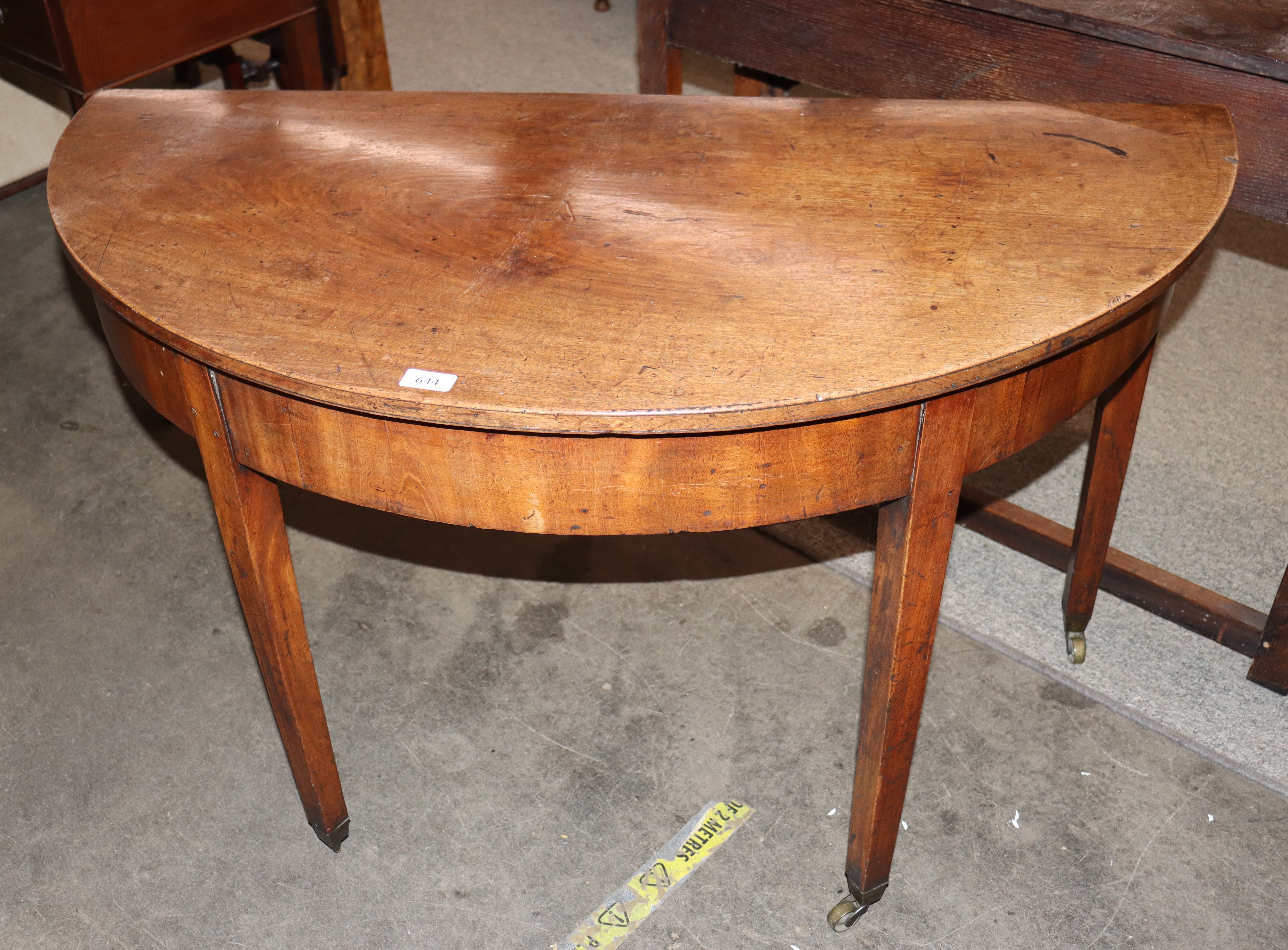 A 19th Century mahogany single drop leaf dining table, raised on square section supports terminating