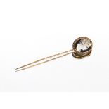 A cased gold stick pin with cameo set terminal