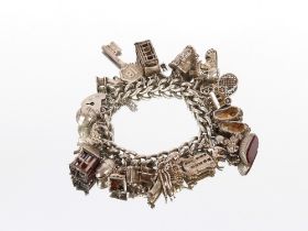 A very large silver charm bracelet, set many charms, 111gms