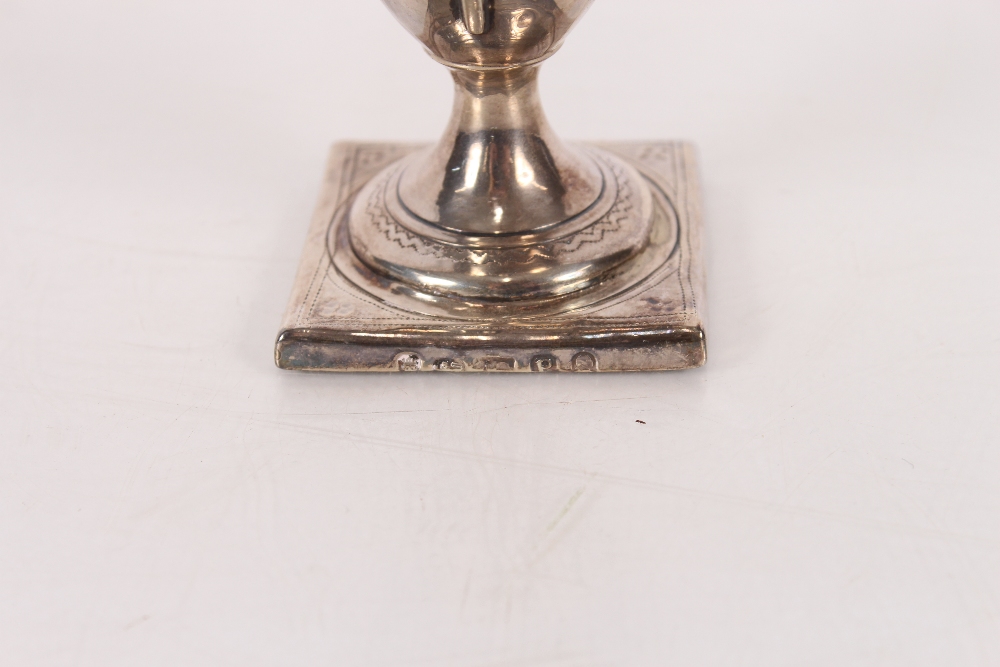 A George III silver pedestal cream jug, having naïve foliate engraved decoration, spread foot set to - Image 2 of 3