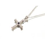An 18ct white gold diamond and sapphire set cross and fine link chain, 6.6gms