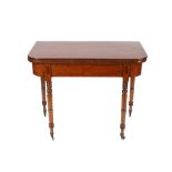 A 19th Century mahogany and ebony strung fold over card table raised on ring turned tapering