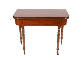 A 19th Century mahogany and ebony strung fold over card table raised on ring turned tapering