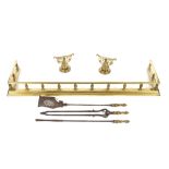 A Victorian brass fender, 139cm wide; a set of three steel and brass fire implements; a pair of