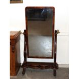 A 19th Century mahogany cheval mirror, the oblong plate flanked by brass adjustable candle sconces