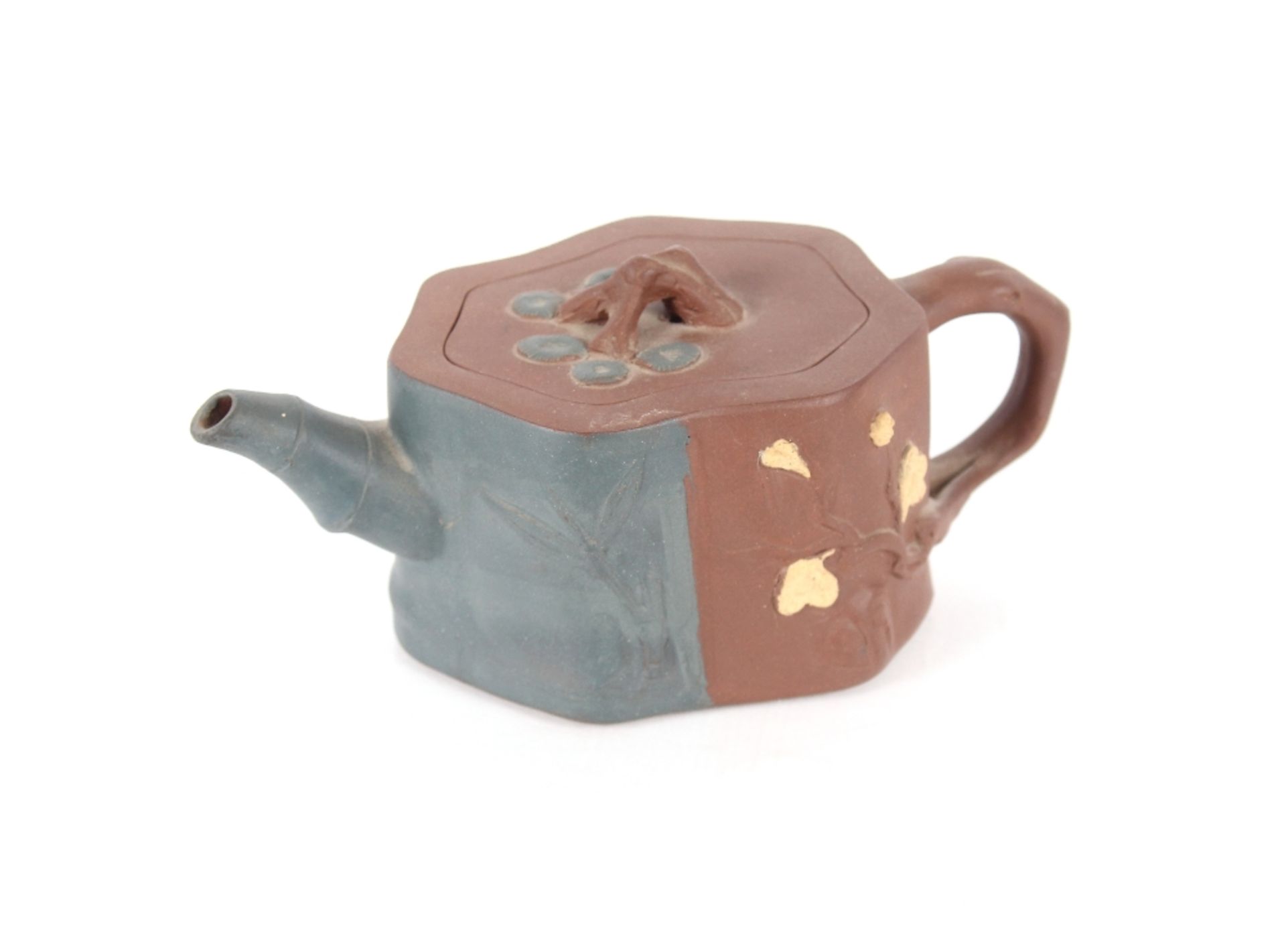 A small Chinese Yixing clay teapot, having raised foliate decoration, seal mark to base, 16cm