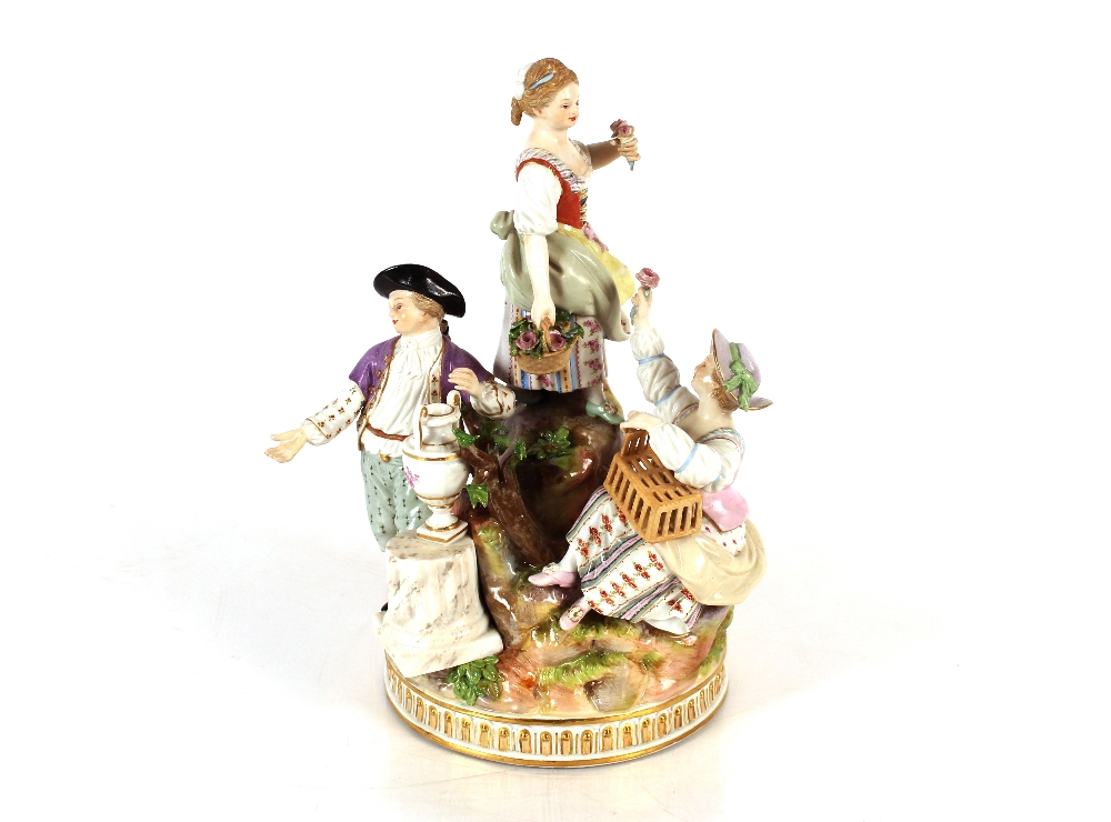 A 19th Meissen figure group, depicting flower sellers and a street vendor gathered around a tree