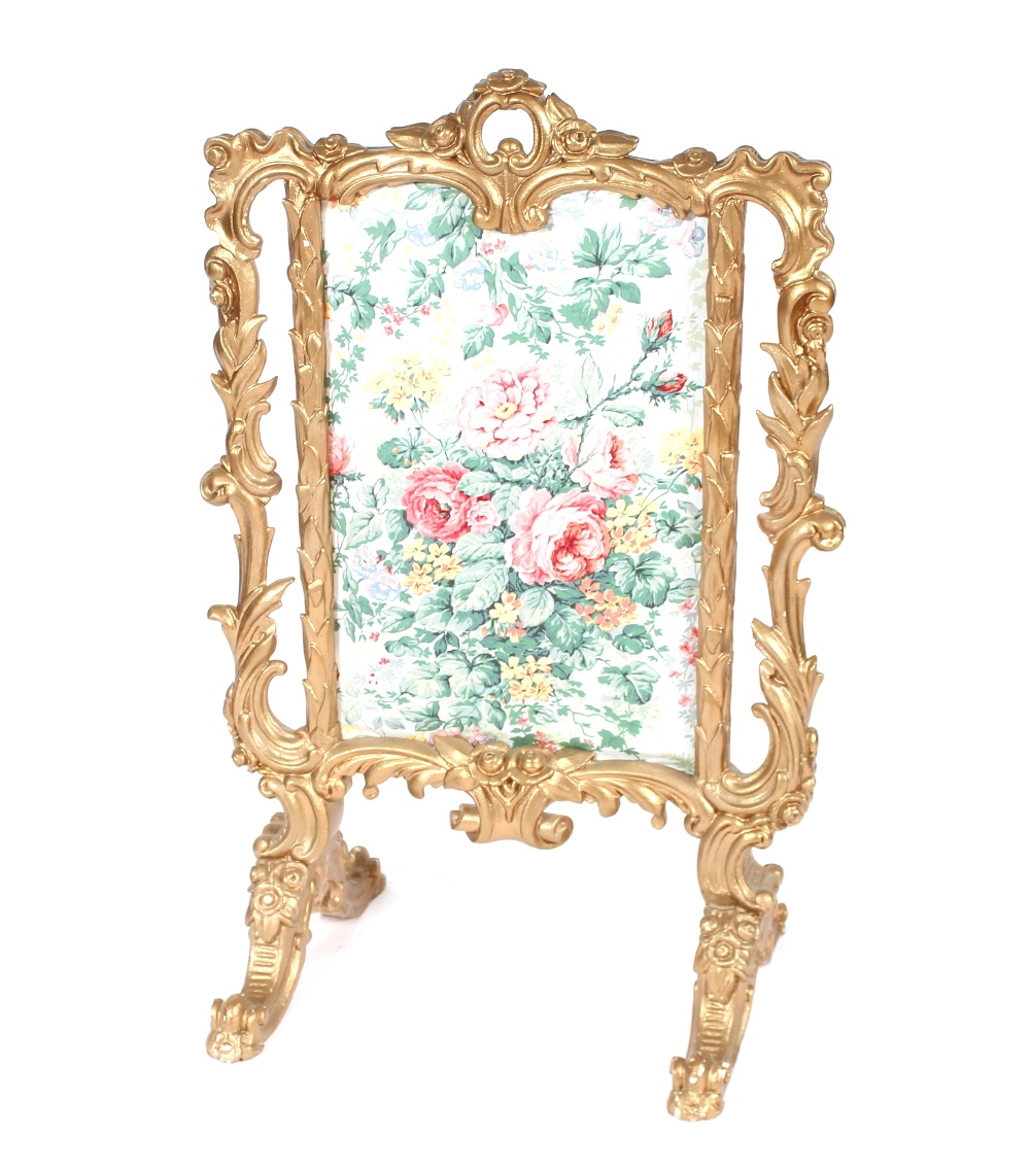 A decorative gilt fire screen in the Rococo manner, having floral panel, 62cm wide x 100cm high