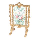 A decorative gilt fire screen in the Rococo manner, having floral panel, 62cm wide x 100cm high