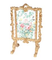 A decorative gilt fire screen in the Rococo manner, having floral panel, 62cm wide x 100cm high