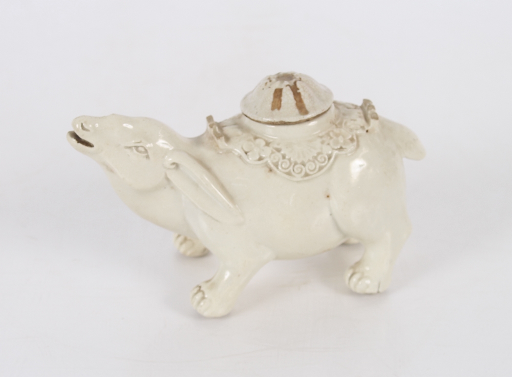 A Chinese blanc de chine water dropper in the form of a water buffalo, having domed detachable