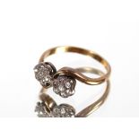 An 18ct gold and diamond cross over ring, 2.5gms,