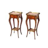 A pair of 19th Century French walnut and cross banded two tier side tables surmounted by pierced