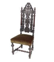 An antique carved oak hall or side chair, with pierced foliate decoration flanked by turned columns,