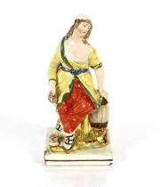 A Staffordshire Ralph Wood type figure of a seated maiden, 24cm high