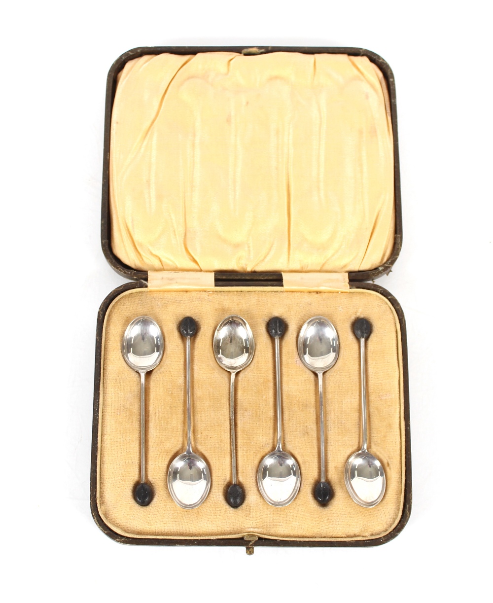 A cased set of six silver bean topped coffee spoons