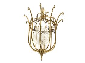 A decorative brass hanging lamp, having raised foliate and scroll decoration, 55cm overall