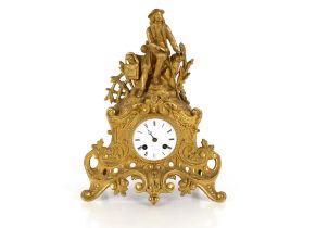 A 19th Century French gilt mantel clock, the case surmounted by a seated figure, circular white