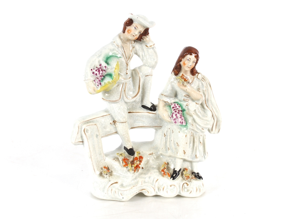 A Staffordshire spill holder in the form of a maid and youth beside a stoop of corn, 17cm high; - Image 2 of 2