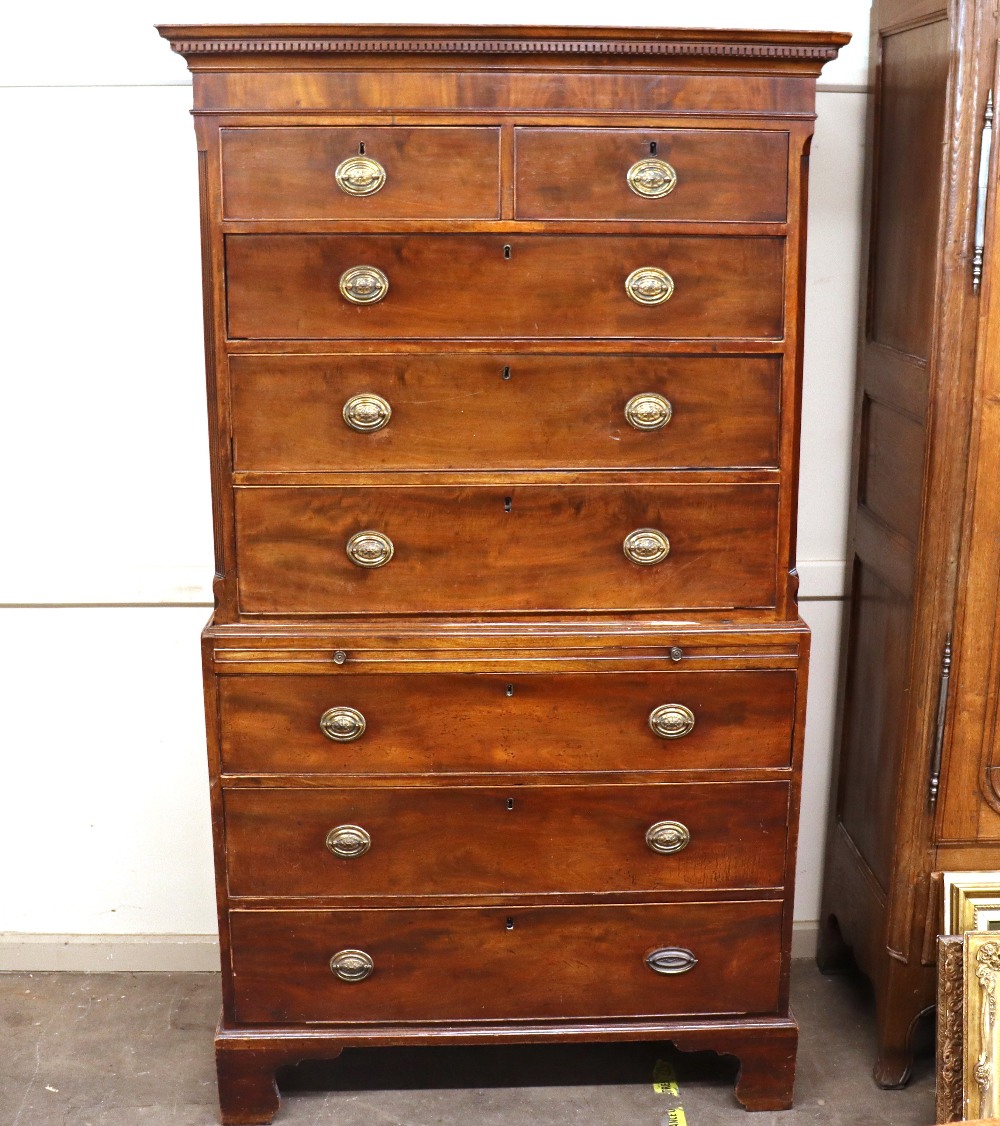 A George III mahogany chest on chest, the upper section fitted two short and three long drawers