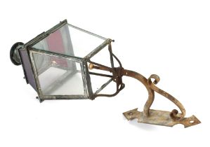 A Victorian copper clear and coloured glass panelled street lamp, on iron bracket, 134cm overall
