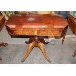 A 19th Century mahogany fold over tea table, the canted corner swivel top raised on a turned