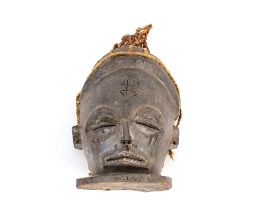 A carved wooden Ethnic face mask with plaited straw work decoration, the forehead with carved motif,