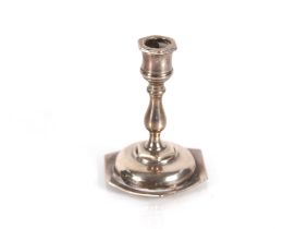 A miniature silver candlestick Birmingham 1897; an Edwardian silver teaspoon in the form of an