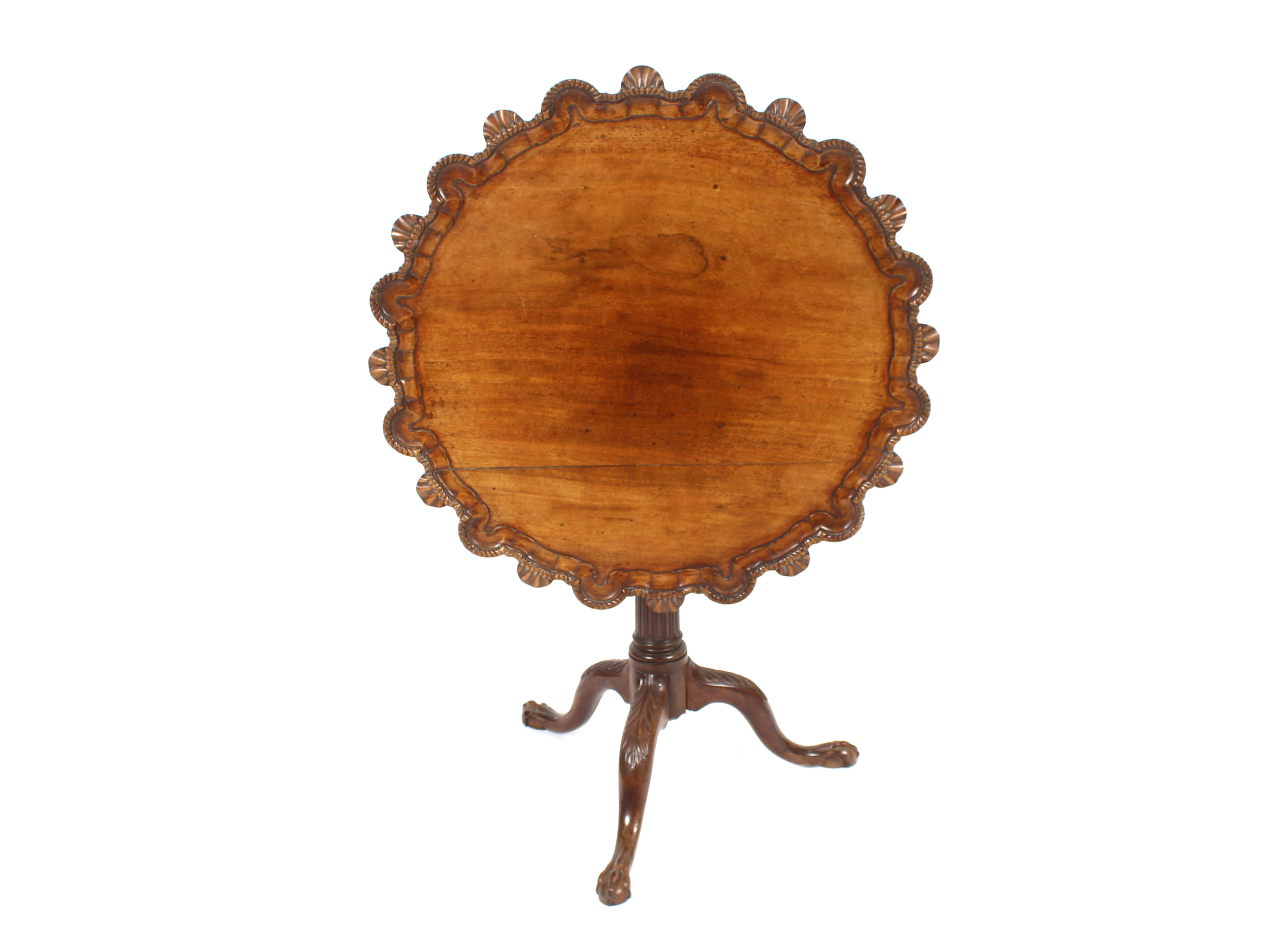 A 19th Century carved mahogany tripod occasional table, the shaped shell decorated top raised on a