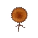 A 19th Century carved mahogany tripod occasional table, the shaped shell decorated top raised on a