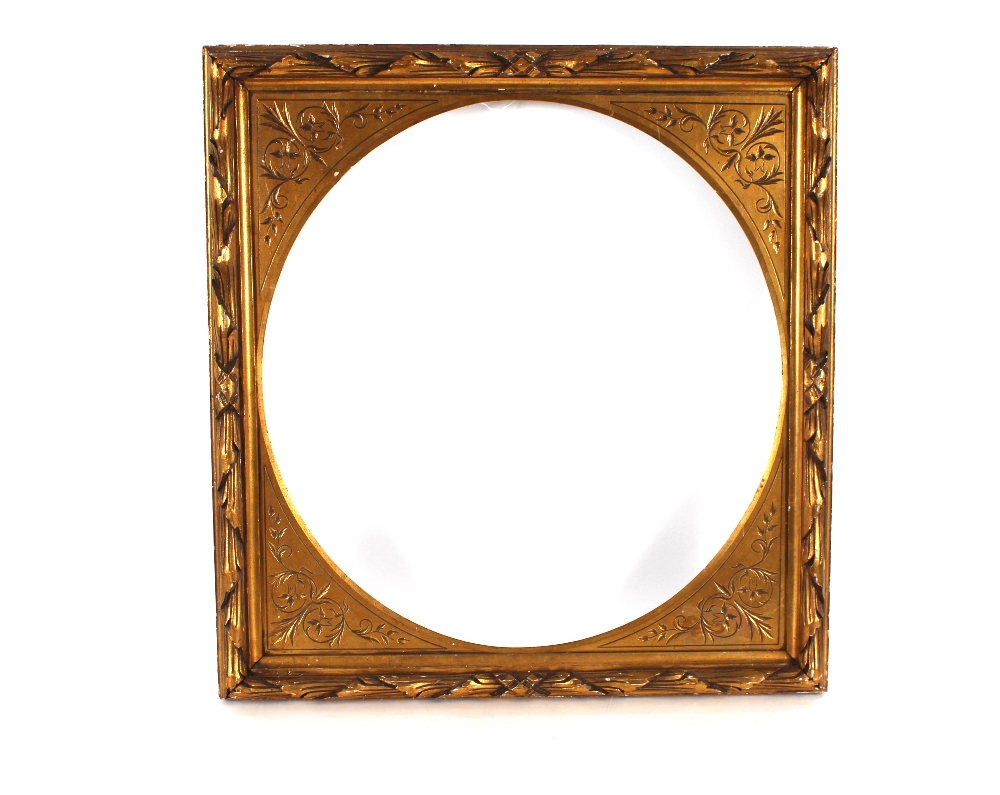 A carved gilt wood picture frame of large proportions with oval insert, 77cm x 73cm overall