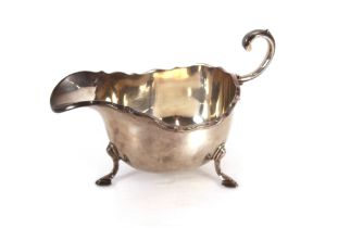 A silver sauce boat, Birmingham 1933, retailed by Harrods, having flying C scroll handle and