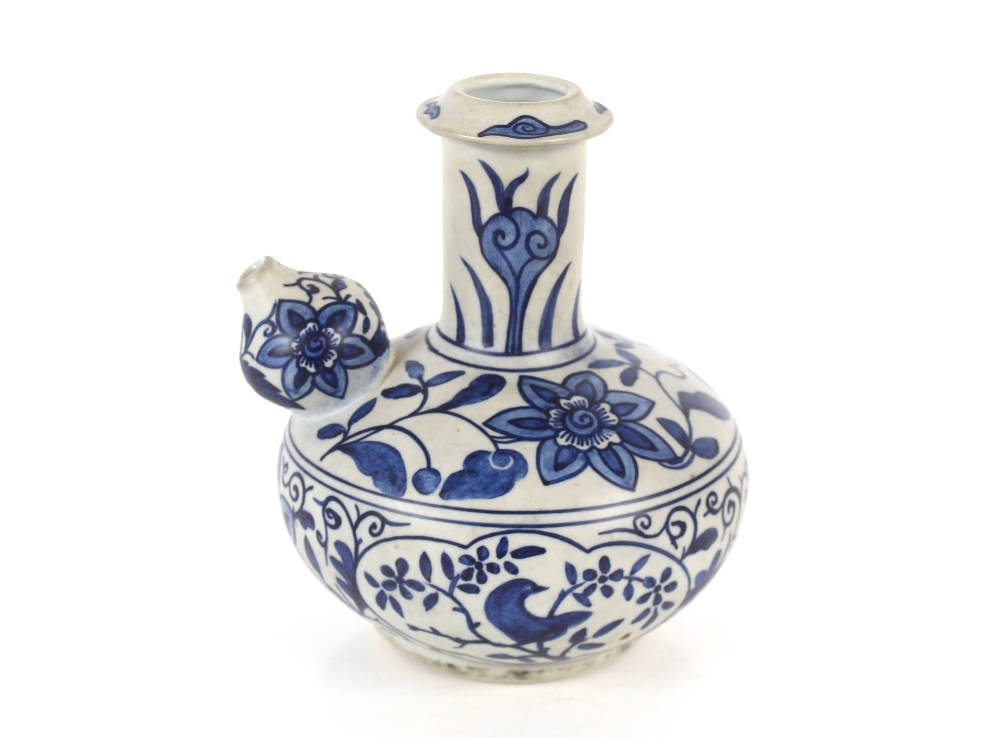 A Chinese Ming style Kendi of traditional form, blue glazed floral and bird decoration, 18cm high