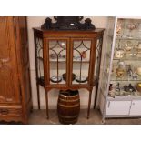 An Edwardian inlaid mahogany china display cabinet of wedge shape, the silk lined interior