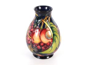 A Moorcroft fruit decorated baluster vase, with original box, 20cm high